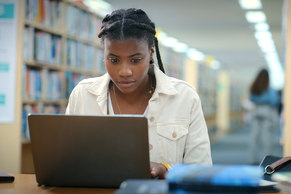 College student on laptop in library