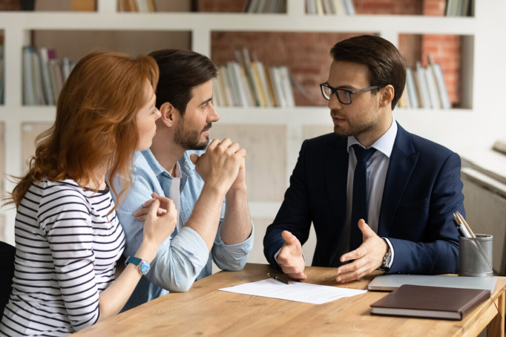 Lawyer meeting with husband and wife to discuss Probate vs. Trust administration in Illinois